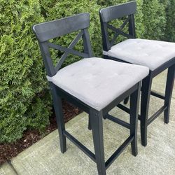 two solid wood counter top chairs with cushions removable in great condition 25 in H
