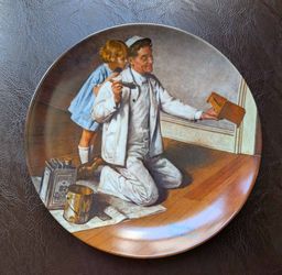 This is a 1983 vintage collector's plate titled "The Painter" by Norman Rockwell, manufactured by the Edwin M. Knowles company.