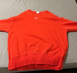 A red orange Nike sweater
