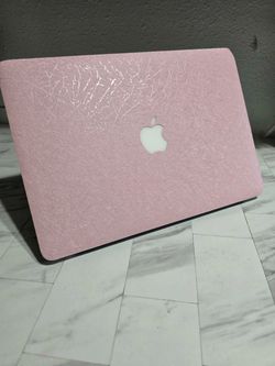 PINK MacBook Air 13-inch from 2015 with 8GB RAM, 128GB SSD, and Intel i5 processor. Running macOS Ventura. Screen and keyboard are in good condition w