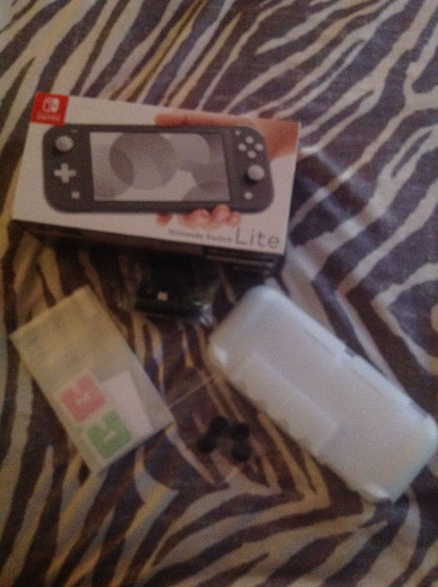 Unopened Nintendo Switch Lite (color grey) with accessories included