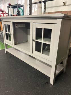 Tv Stand Upper and Lower storage 54” wide, 32” tall and has adjustable shelving and tempered-glass doors.