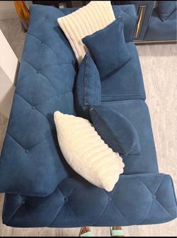 Blue tufted sofa