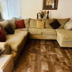 Khaki Colored Two Piece Sectional Along With Coffee Table, One End Table In A Sofa Table