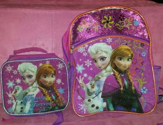 Frozen back pack has slight tear across top w/lunch box
