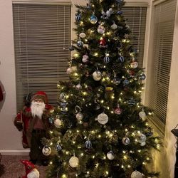 Artificial Christmas tree with built-in lights and a full set of ornaments. In great condition, perfect for the holidays
