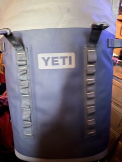YETI Hopper M20 Backpack Cooler in navy blue, featuring a durable, waterproof exterior with MOLLE-style straps.