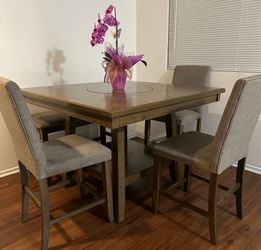 Dinner table with 3 high chairs and 1 bench.