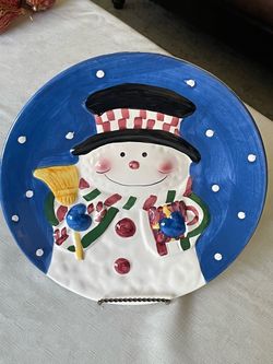 International Bazaar decorative ceramic holiday plate featuring an embossed snowman. 12”