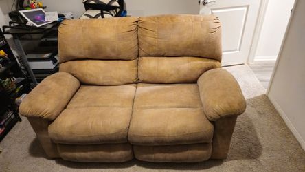 Loveseat With Black Cover And Pillows.