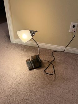 Desk lamp with outlets and storage compartment