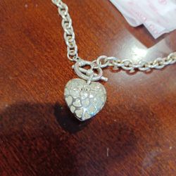 Juicy Couture.  Silver choker or a double Bracelet. 