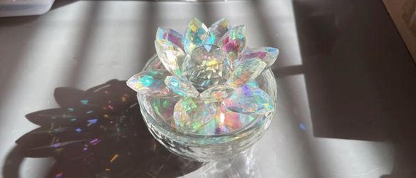 Iridescent clear crystal lotus sculpture adds elegant sparkle to any room. Light-catching facets