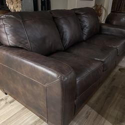 Leather couch and loveseat hundred percent leather great condition brown in color