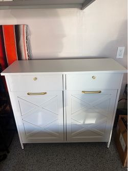 Cabinet with pull out drawers trash or laundry hamper