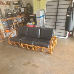 Rattan  sofa with leather cushions.