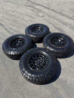 FINANCING AVAILABLE KMC KM718 Summit 6x5.5 17" Wheels with 34" Nitto RidgeGrappler Tires