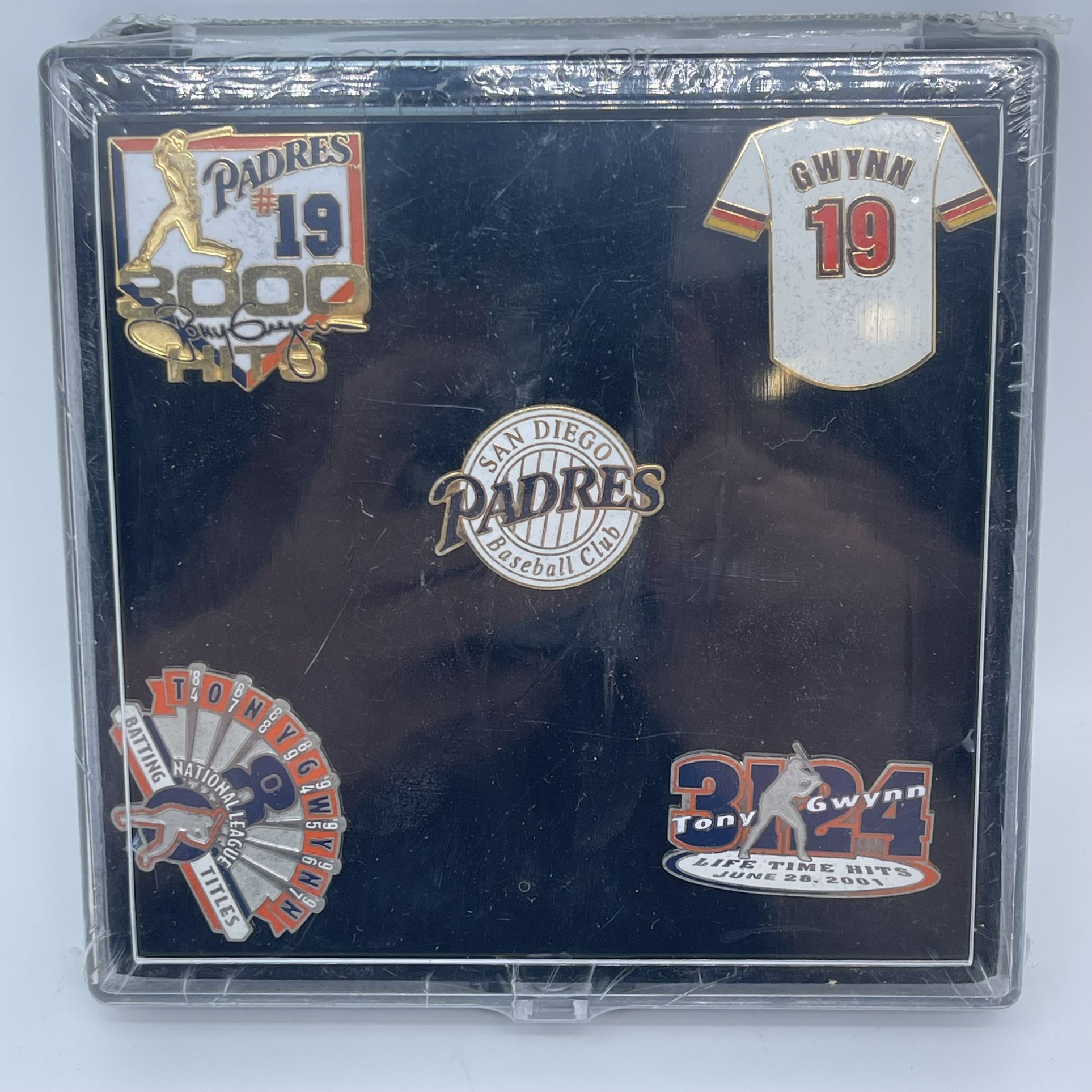 This vintage pin set features Tony Gwynn, a legendary baseball player who played for the San Diego Padres. The set includes a rare pin with the number