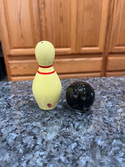 Ceramic Souvenir Bowling Ball and Pin Pair of Salt and Pepper Shakers.  Size bowling pin approximately 3 1/2 inches tall.  Made in Japan foil stickers