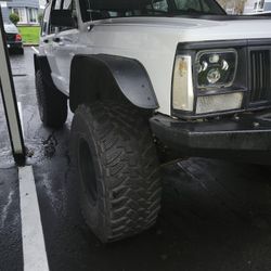 4 - 33x13.50r15 Toyo Open Country MTs on black wheels