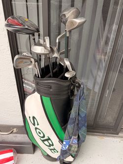 Vintage Sobe golf bag with assorted golf clubs