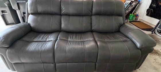 Leather sofa with dual recliners