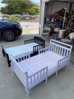 Two toddler beds with mattresses
