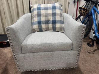 Two gray upholster swivel accent chairs