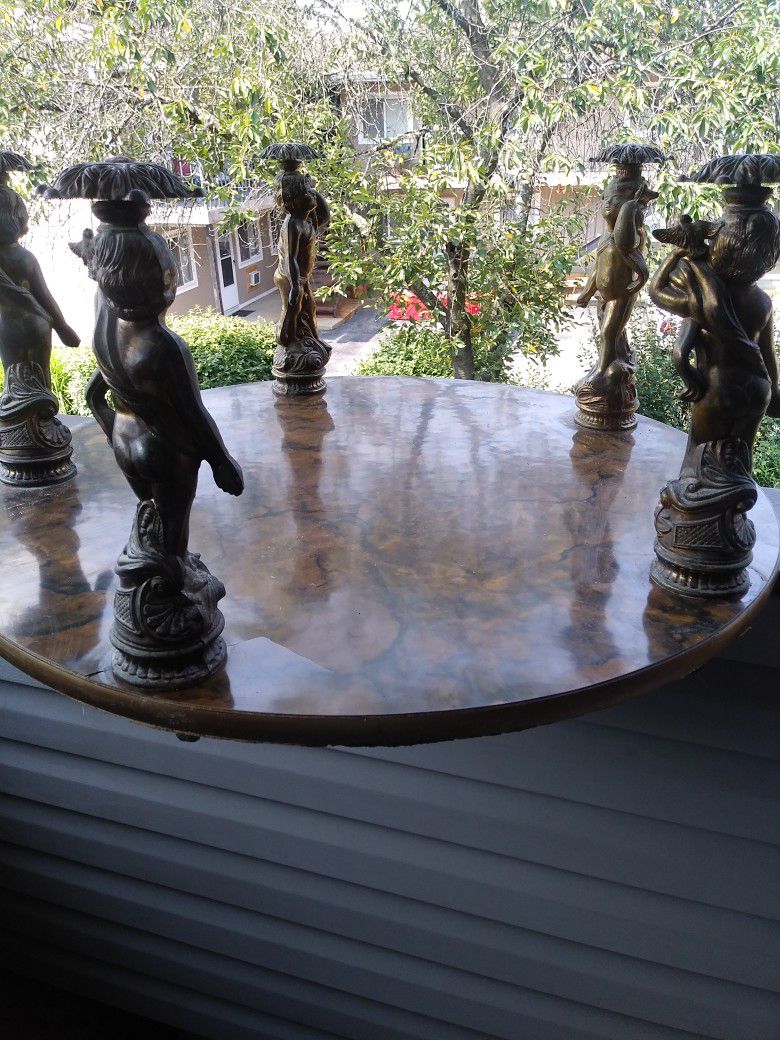 Hollywood Floor Table. 5 Metal Figurine Of Cherubs On Top. NEW PRICE $10. FINAL PRICE