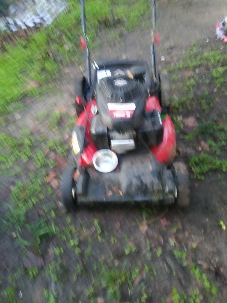 A crabman Troy-Bilt push lawn mower with self propelled with a Honda motor