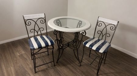Vintage glass dining table with matching metal chairs