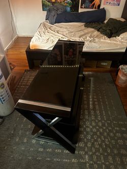black glass and stainless steel console table closely resembles the Whalen Xavier 3-in-1 TV Stand