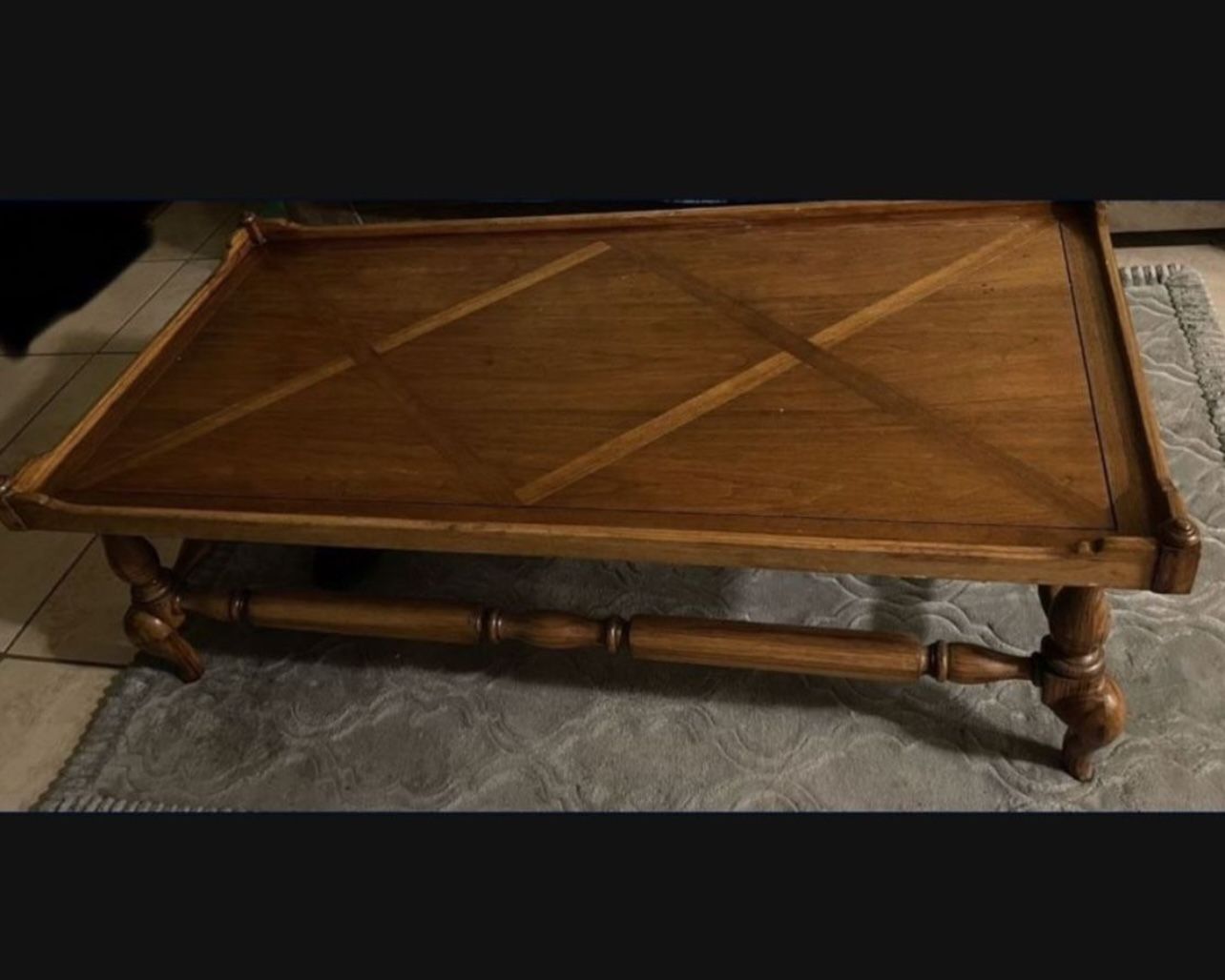 Antique coffee table with inlaid wood.