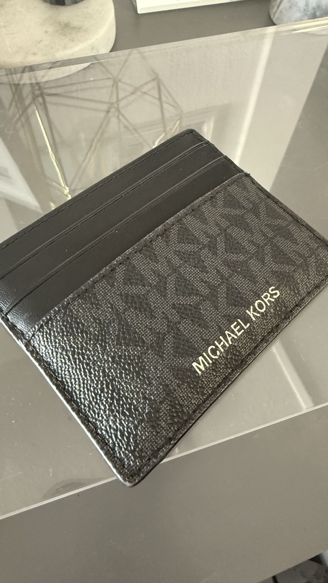 Stylish Michael Kors card case in a sleek gray + black design.