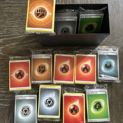 Trainer Box filled with 12 packs of sealed energy cards