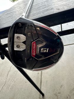 TaylorMade R15 460 driver with a 9.5-degree loft. This club has a white crown and a black sole with adjustable sliding weights for draw and fade bias.