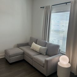 Modern gray sofa with ottoman