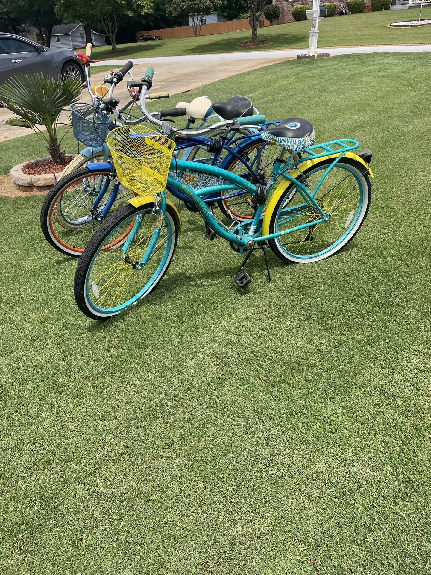 Two Margaritaville cruiser bikes and one Huffy Nel Lusso