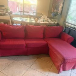 The red fabric sofa is super comfortable