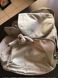 Stylish Coach crossbody bag has signature brown monogram canvas with yellow and black snakeskin leather detail. Bag features adjustable cream fabric s