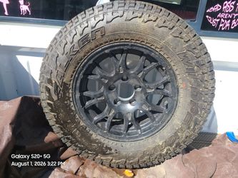 Falken Wildpeak A/T tire mounted on a black multi-spoke wheel.