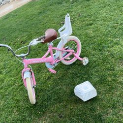 Pink bike with training wheels