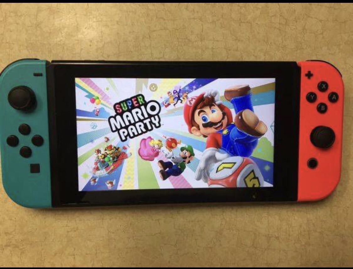 NINTENDO SWITCH with 55 GAMES MARIO KART, ANIMAL CROSSING, LUIGIS MANSION, ZELDA, POKEMON and More