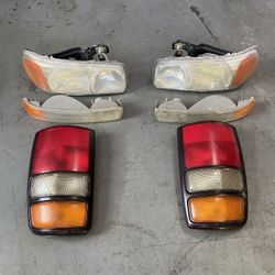 2000-2006 Gmc, Yukon, Headlights And Side, Lens And Tail Lights A Compete Set OEM