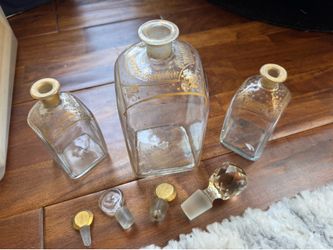 Antique vintage glass bottles with gold embossing