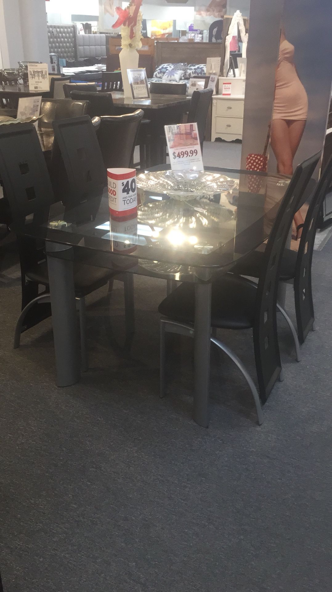 Dinning set. Table and 4 black leather chairs with chrome edging, the table is double level glass with top black tent and gray legs all brand new in