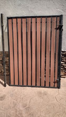 Black metal door gate. Wood panel.  Size 54" inches. Wide.  X. 70 inches tall.  -$ 190 ...