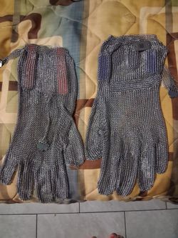This is a stainless steel chainmail protective glove often used in butchery or meat cutting for cut resistance.