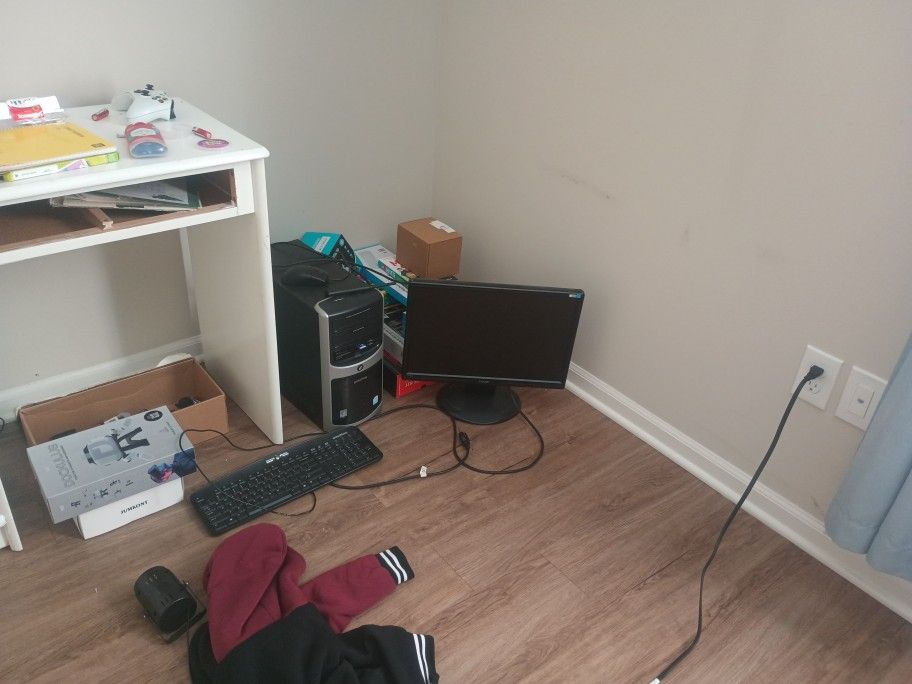 A Windows Vista Computer With The Monitor And The Keyboard, Mouse, Antenna, And Lastly A SD Card And A GoPro