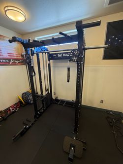 Smith machine squat rack home gym dumbbells kettlebells rubber flooring bench bar leg press weights bumper plates